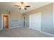 Bedroom with ceiling fan, double doors, and carpet flooring at 36145 N Desert Tea Dr, Queen Creek, AZ 85140