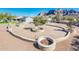 Landscaped backyard with circular patio and fire pits at 5365 E Shiprock St, Apache Junction, AZ 85119