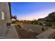 Landscaped backyard with string lights and desert landscaping at night at 5365 E Shiprock St, Apache Junction, AZ 85119