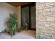 Private courtyard entry with stonework and drought-tolerant landscaping at 6321 E Phoenician Blvd # 14, Scottsdale, AZ 85251