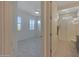 Bedroom with window shutters and view into bathroom at 16375 S 180Th Dr, Goodyear, AZ 85338