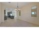 Bright dining room with kitchen view and modern chandelier at 16375 S 180Th Dr, Goodyear, AZ 85338