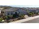 Modern home with tile roof, landscaping, and mountain views at 16375 S 180Th Dr, Goodyear, AZ 85338