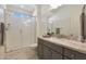 Bathroom with gray vanity, granite countertop, and walk-in shower at 16375 S 180Th Dr, Goodyear, AZ 85338