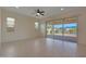 Living room with sliding doors to backyard patio and pond view at 16375 S 180Th Dr, Goodyear, AZ 85338
