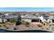 Aerial view of a luxury community with lake, homes, and mountain backdrop at 16375 S 180Th Dr, Goodyear, AZ 85338