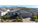 Modern home with tile roof, landscaping, and mountain views at 16375 S 180Th Dr, Goodyear, AZ 85338