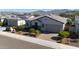 Modern home with tile roof, landscaping, and mountain views at 16375 S 180Th Dr, Goodyear, AZ 85338