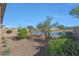 Landscaped backyard with lake view and desert plants at 16375 S 180Th Dr, Goodyear, AZ 85338