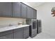 Laundry room with gray cabinets, washer, and dryer at 16375 S 180Th Dr, Goodyear, AZ 85338