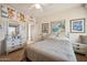 Bright bedroom with double bed, dresser, and artwork at 25210 N 90Th Way, Scottsdale, AZ 85255