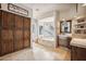 Elegant bathroom with double vanity, soaking tub, and glass block window at 25210 N 90Th Way, Scottsdale, AZ 85255