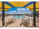 Community pool under shade structures, inviting seating areas at 10124 E Cintron Dr, Mesa, AZ 85212