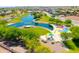 Aerial view showing a community featuring a lake, playground, and walking paths at 37274 W Amalfi Ave, Maricopa, AZ 85138