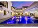 Night view of a luxury pool and patio with water features at 1480 E Raven Ct, Gilbert, AZ 85297