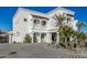 White stucco home with palm trees and a large paved driveway at 1480 E Raven Ct, Gilbert, AZ 85297
