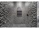 Shower with geometric patterned tiles and a niche at 1480 E Raven Ct, Gilbert, AZ 85297