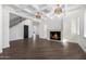 Elegant living room with hardwood floors, a fireplace, and high ceilings at 1480 E Raven Ct, Gilbert, AZ 85297