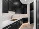 Modern kitchen features white quartz countertops, herringbone backsplash, and dark cabinetry at 1480 E Raven Ct, Gilbert, AZ 85297