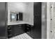 Modern bathroom with black cabinetry, gray tile, and corner sink at 1480 E Raven Ct, Gilbert, AZ 85297