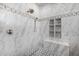 Large walk-in shower with marble tile, built-in shelves, and gold fixtures at 1480 E Raven Ct, Gilbert, AZ 85297