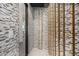 Elegant wine cellar with gold racks and stone wall at 1480 E Raven Ct, Gilbert, AZ 85297