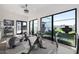 Home gym with various equipment and backyard views at 1480 E Raven Ct, Gilbert, AZ 85297