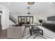 Modern living room features a sectional sofa, coffee table, and large TV at 1480 E Raven Ct, Gilbert, AZ 85297