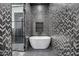 Bathroom with freestanding bathtub and a chevron-patterned tile shower at 1480 E Raven Ct, Gilbert, AZ 85297