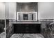 Bathroom with double vanity, marble, and black cabinets at 1480 E Raven Ct, Gilbert, AZ 85297