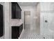 Spa-like bathroom with black cabinets, marble tile, and a hallway at 1480 E Raven Ct, Gilbert, AZ 85297