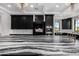 Modern kitchen with black cabinets and marble countertops at 1480 E Raven Ct, Gilbert, AZ 85297