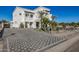 Elegant home with a checkered driveway and desert landscaping at 1480 E Raven Ct, Gilbert, AZ 85297