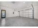 Bright and spacious garage featuring an epoxy floor and a convenient door at 1480 E Raven Ct, Gilbert, AZ 85297