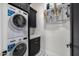 Laundry room with stackable washer and dryer, black cabinets, and white countertop at 1480 E Raven Ct, Gilbert, AZ 85297