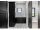 Modern laundry room with black cabinets and patterned tile at 1480 E Raven Ct, Gilbert, AZ 85297