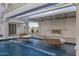 Serene pool area with hanging daybeds and a waterfall feature at 1480 E Raven Ct, Gilbert, AZ 85297