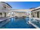 Inviting pool and spa with hanging daybeds and a fireplace at 1480 E Raven Ct, Gilbert, AZ 85297