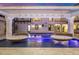 Tranquil pool scene with hanging daybeds and a fireplace at 1480 E Raven Ct, Gilbert, AZ 85297