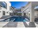 Luxury pool with waterfall feature and hanging daybeds at 1480 E Raven Ct, Gilbert, AZ 85297