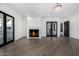Bright living room features a marble fireplace, hardwood floors, and French doors leading to a balcony at 1480 E Raven Ct, Gilbert, AZ 85297