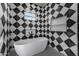 Modern bathroom with freestanding tub, geometric tile, and black accents at 1480 E Raven Ct, Gilbert, AZ 85297