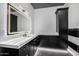 Chic bathroom with black and white marble tile, a large mirror, and a corner vanity at 1480 E Raven Ct, Gilbert, AZ 85297