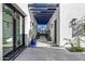 Elegant courtyard entry with a pergola, tile flooring, and gated access at 1480 E Raven Ct, Gilbert, AZ 85297