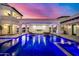 Expansive pool and spa with hanging daybeds and a fireplace at 1480 E Raven Ct, Gilbert, AZ 85297