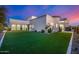 Luxury home with expansive backyard, featuring artificial turf and mature landscaping at 1480 E Raven Ct, Gilbert, AZ 85297