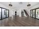 Open living area with hardwood floors, large windows, and access to a patio at 1480 E Raven Ct, Gilbert, AZ 85297