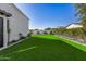 Artificial turf side yard with mature shrubs and trees at 1480 E Raven Ct, Gilbert, AZ 85297