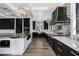 Modern kitchen with black cabinets and marble countertops at 1480 E Raven Ct, Gilbert, AZ 85297