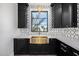 Butler's pantry with gold sink and black cabinets at 1480 E Raven Ct, Gilbert, AZ 85297